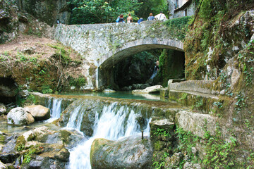 rocky bridge of candalla over the river waters in the Tuscan mountains