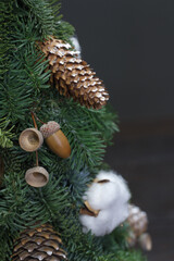 Christmas tree made of fresh Nobilis spruce, decorated with festive ornaments and pine cones