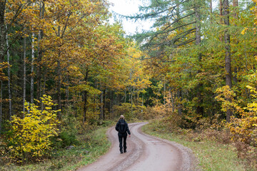 Trekking an a winding gravel road in fall season