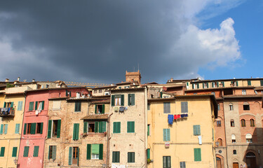 Fototapeta na wymiar Facades of row houses in Sienna Italy