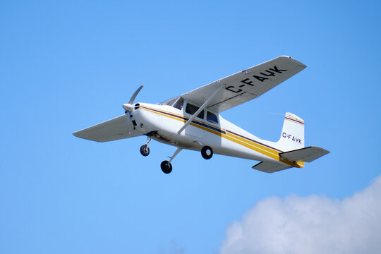 Ottawa, Canada. August 30, 2020. White and brown Cessna 172M Skyhawk plane in flight after taking off from Rockcliffe airport in Ottawa