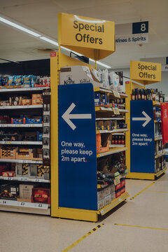 Stow-on-the-Wold, UK - July 7, 2020: One way system and social distancing signs inside Tesco supermarket due to Coronavirus pandemic, Stow on the Wold, UK.