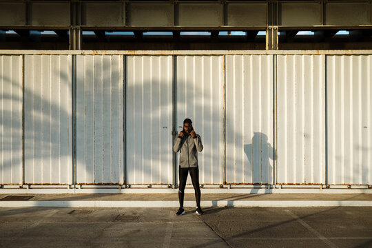 Calm confident ethnic man against gray wall