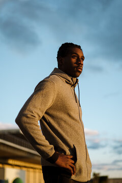 Calm confident ethnic man during sunset
