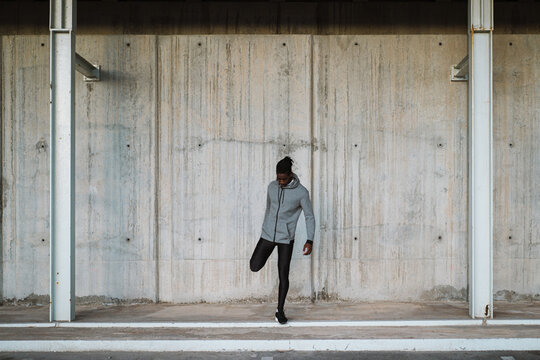 Solitary ethnic determined sportsman training on street