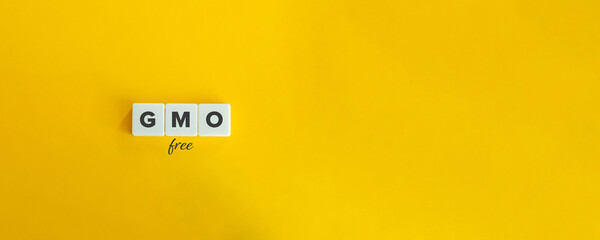 Obraz premium GMO free or Non-GMO banner and concept. Block letters on bright yellow orange background. Minimal aesthetics.