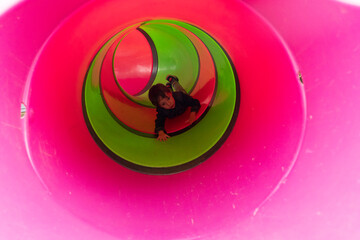boy jumping tube slide