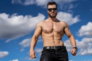 Portrait of a handsome halfnacked bodybuilder man in glasses. Half length photo. Attractive...