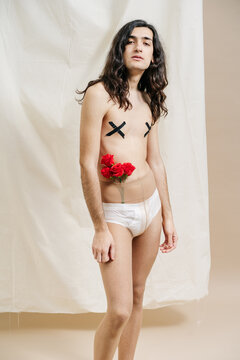 Sexy androgynous model with flowers in tights