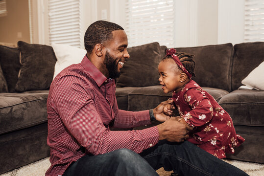 Father and daughter paying and smiling