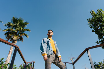 Trendy male near grey stairs