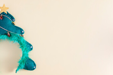 Hoop with New Year Christmas tree on a beige background with copy space: festive party concept