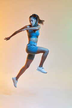 Fit lady jumping during training