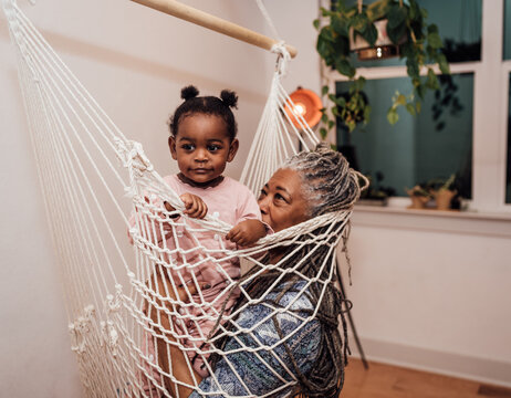 Woman in Hammock sitting with granddaughter
