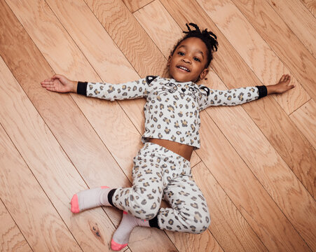 Girl laying on floor smiling