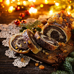 Christmas poppy seed cake, sliced poppy seed cake covered with icing and decorated with raisins on...