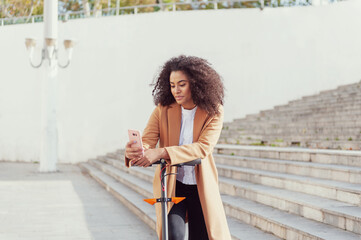 Young woman downloads the application to use the electric scooter in the city streets sustainable lifestyle