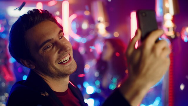 Emotional Man Having Video Call At Party. Candid Guy Using Phone In Nightclub