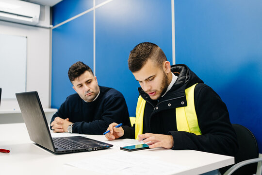 Crop pilots examining flight path on laptop