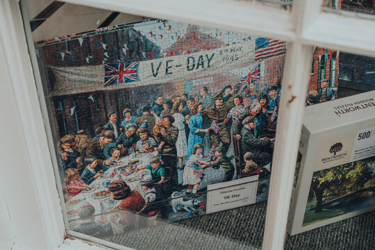 Broadway, UK - July 7, 2020: VE Day themed puzzles on sale in a window of a shop in Broadway, Cotswolds, UK.