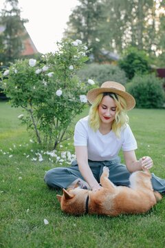 Woman playing with dog in yard
