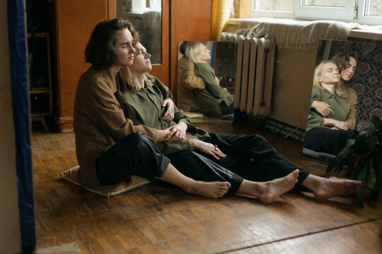 two guys are sitting on the floor in peace