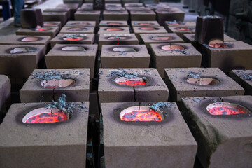 Cooling process of filled sand molds after steel casting, cracked during the process.