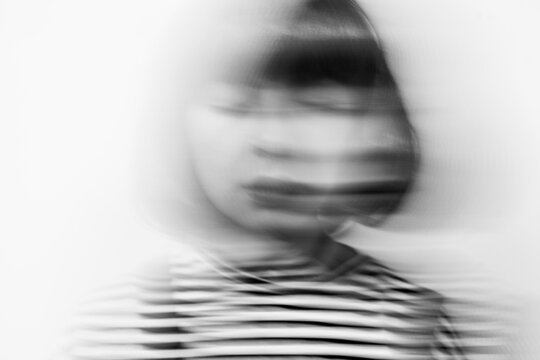 portrait of woman with closed eyes, motion blur
