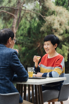 Middle-aged Couple Drinking Tea Outside