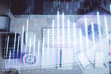 Multi exposure of forex graph drawing over desktop background with computer. Concept of financial analysis. Top view.