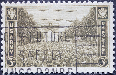 USA - Circa 1945: a postage stamp printed in the US showing .a procession of troops in front of the...