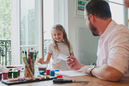 father and daughter spending time together drawing at home, conversation between parent and child