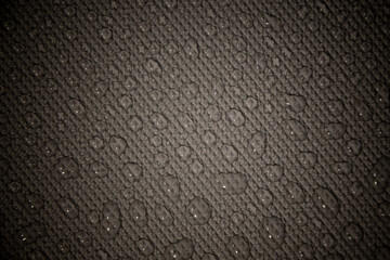 wet with water drops dark grey background with geometrical texture and gradient illumination, closeup, details