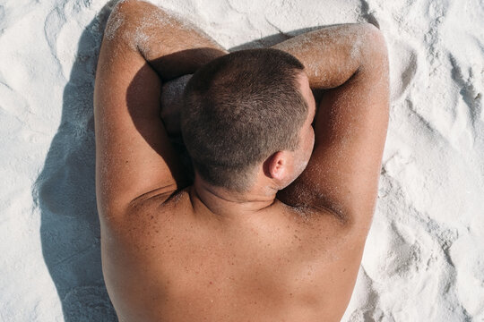 Man Laying On Beach Top View