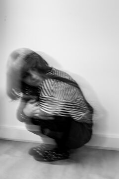 offence, black and white portrait of woman with motion blur