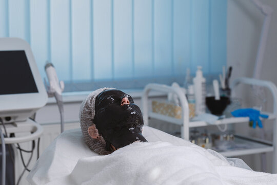 Teenager with alginate mask relaxing during therapy.