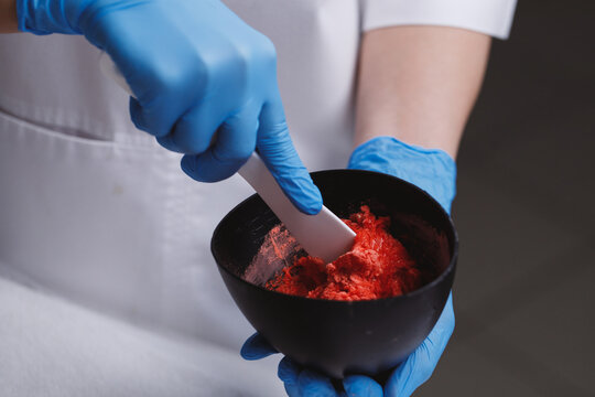 Cosmetologist preparing alginate mask.
