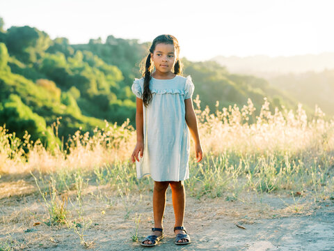 Childhood summer - A young girl stands carefree in tall grasses