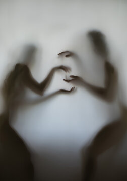 silhouette of a guy and a girl behind the fabric in very beautiful poses