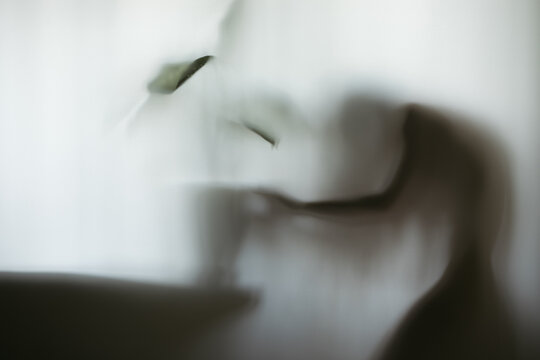 girl posing near a flowerpot by the window