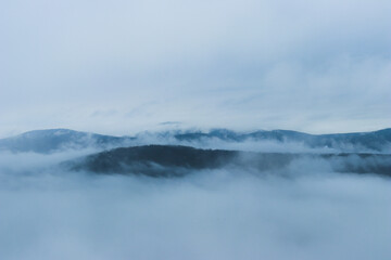 Mountains hide by cold fog