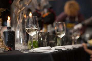 Table set for Halloween dinner. Served holiday table with candles and pumpkin