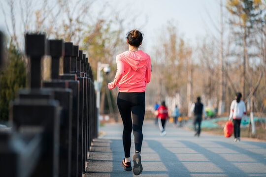 A beautiful Chinese woman running outdoors