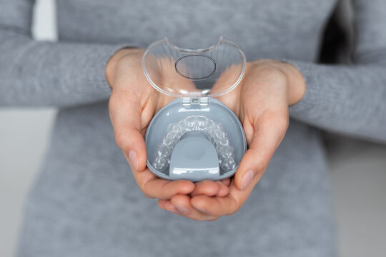 Box with aligners in woman's hands