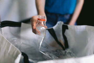 Person sorting home hold plastic trash.