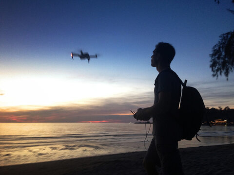 drone pilot silhouette, blurred motion (mobile photo)