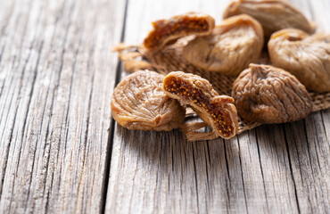 Dried figs on an old wooden background