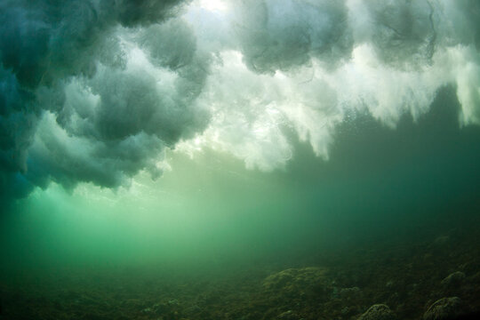 An Underwater Perspective Of A Breaking Wave Exploding Above The Surface