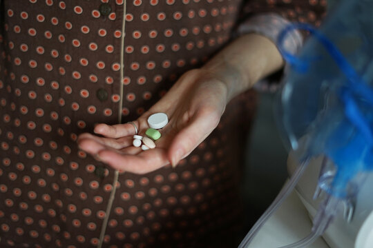 Anonymous woman holding pills on her hand