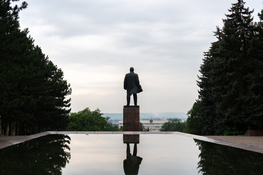 Silhouette of statue of Lenin from behind